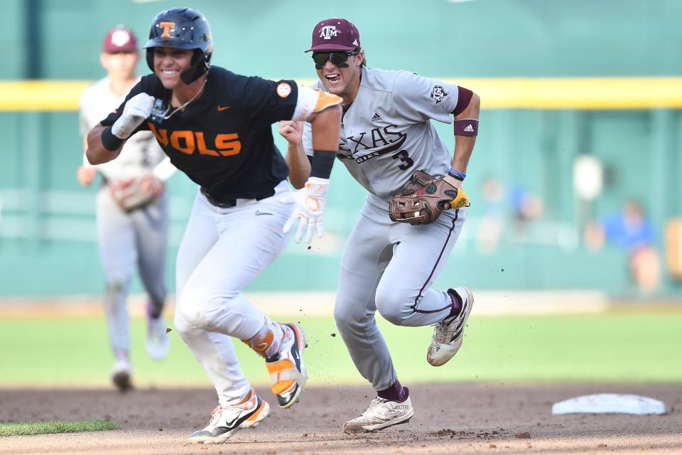 Texas A&M's Kaeden Kent (3) chases down Tennessee's Dean Curley (23) in between first and second base during game three of the NCAA College World Series finals between Tennessee and Texas A&M at Charles Schwab Field in Omaha, Neb., on Monday, June 24, 2024.