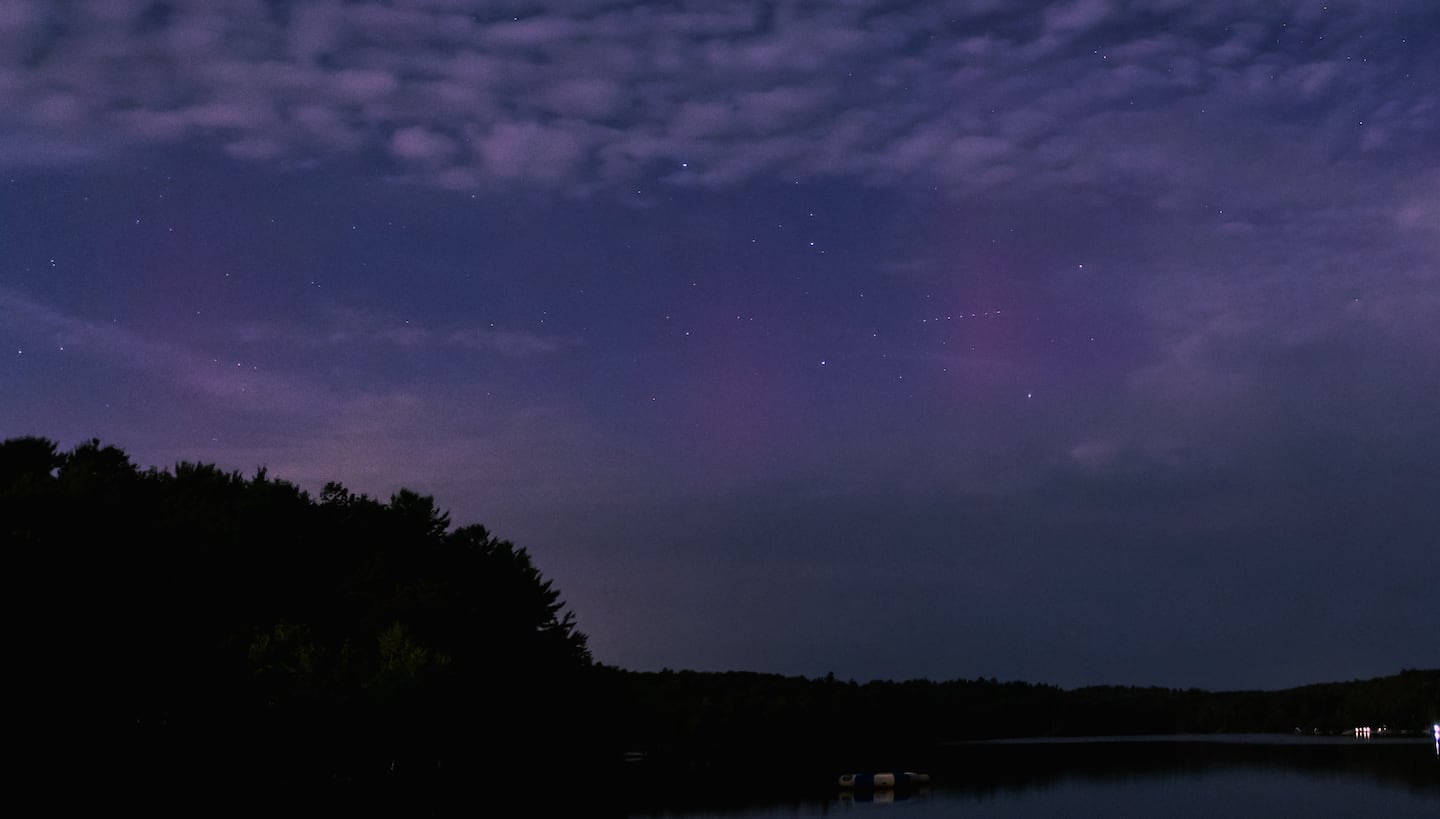 Colorful lights from the aurora borealis through the night sky as seen in Goshen, Mass., Thursday night.