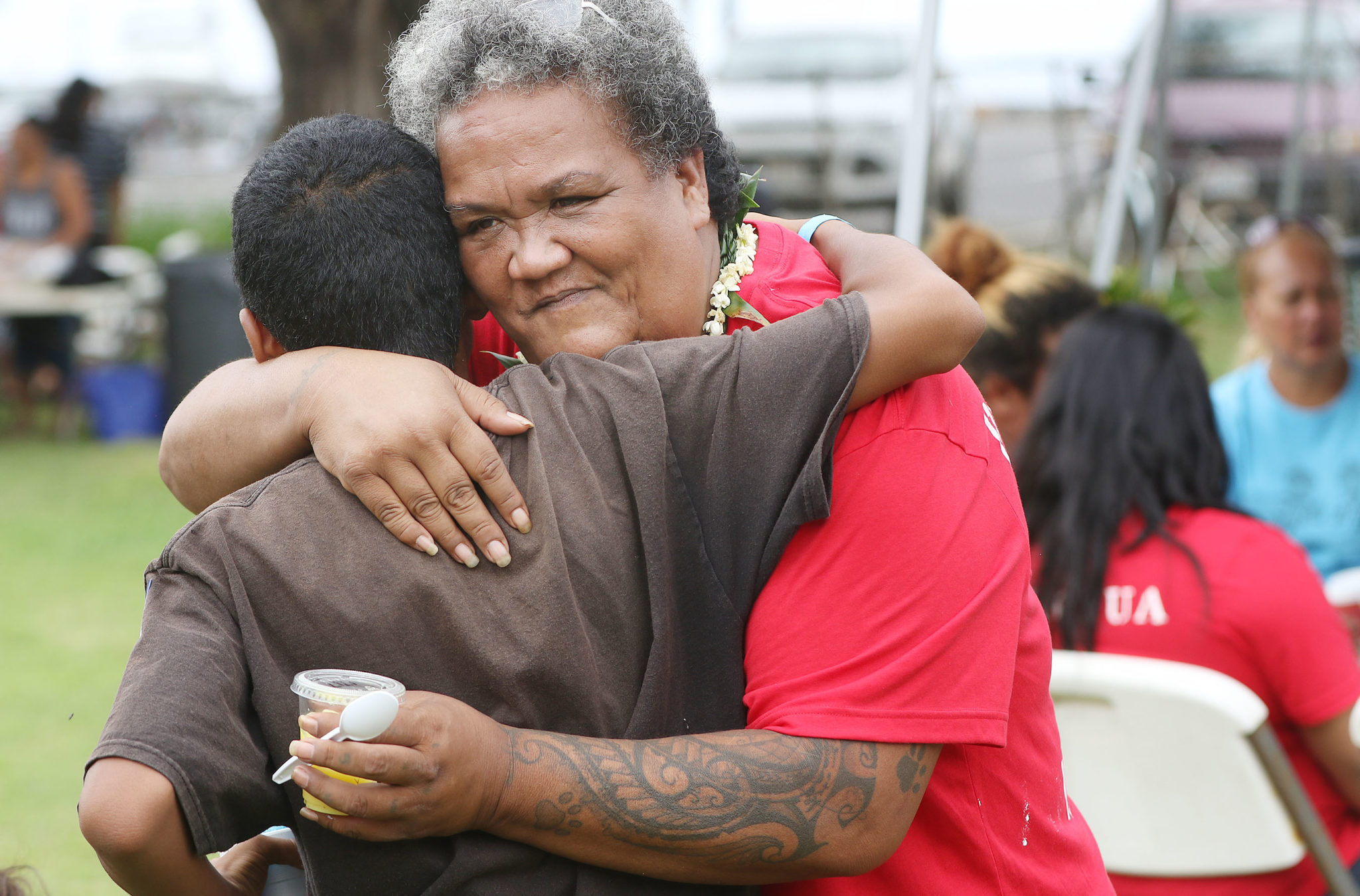 Aunty Twinkle Borge receives a hug during open house held at Puuhonua O Waianae/Waianae Boat Harbor.