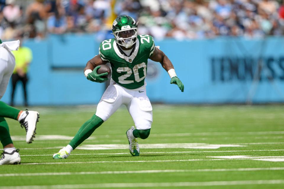 New York Jets running back Breece Hall (20) runs the ball against the Tennessee Titans during the first half at Nissan Stadium.