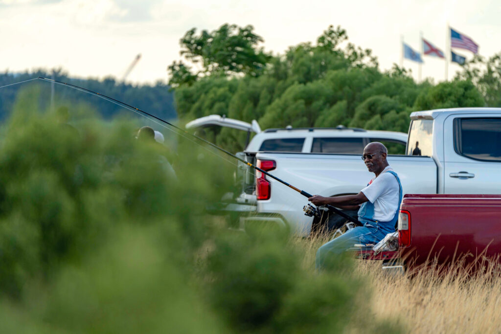 A fisherman tends his line from the Mobile Bay Causeway, a manmade roadway crossing the bay and connecting the city of Mobile, Ala. with suburban communities on the other side. Credit: Lee Hedgepeth/Inside Climate News