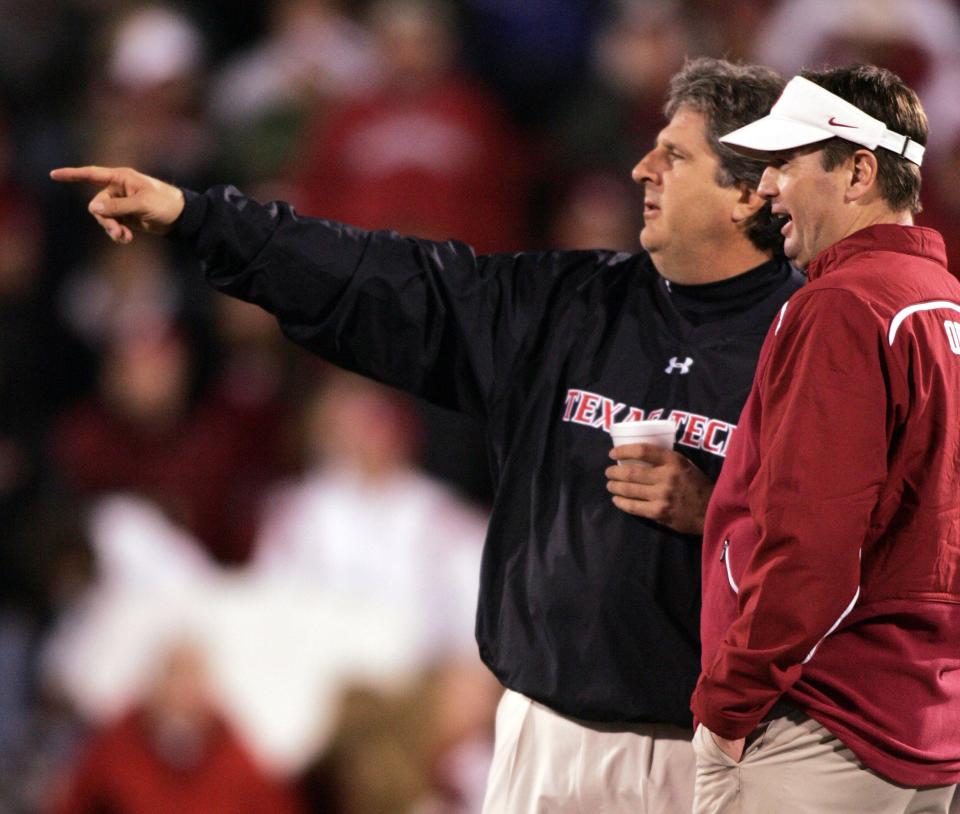 Nov 22, 2008; Norman, OK, USA; Oklahoma Sooners head coach Bob Stoops talks with Texas Tech Red Raiders head coach Mike Leach at Gaylord Family Oklahoma Memorial Stadium in Norman. Oklahoma beat Texas Tech 65-21. Mandatory Credit: Tim Heitman-USA TODAY Sports