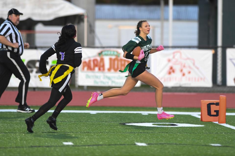 Greenbrier's Pressley McDermott (20) runs into the end zone during the Greenbrier and Miller Grove flag football playoff game at Greenbrier High School on Tuesday, Dec. 5, 2023. Greenbrier defeated Miller Grove 39-0.