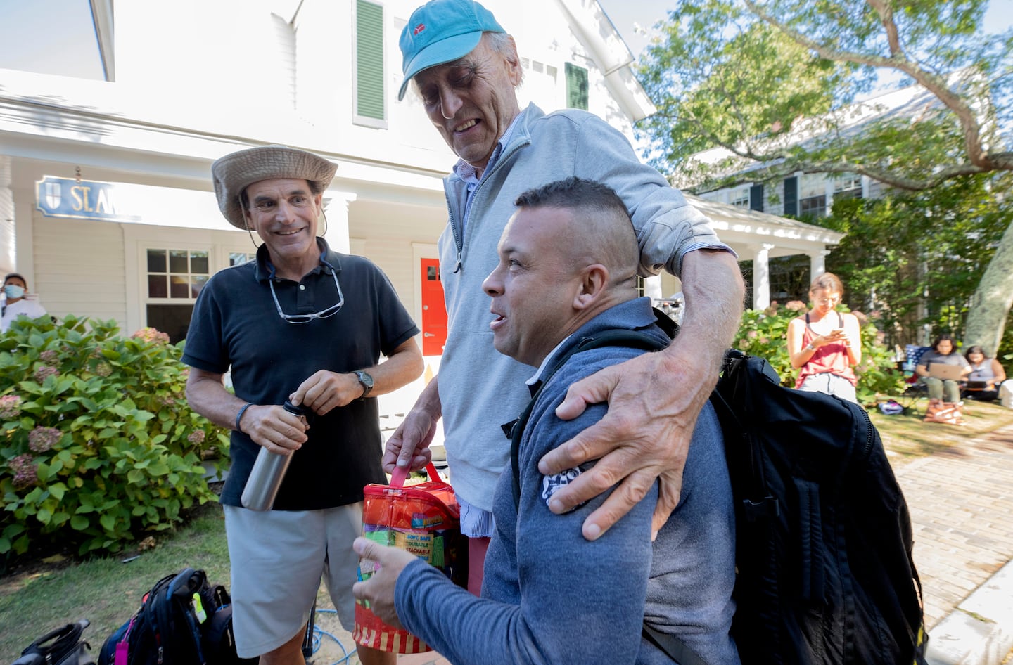 Martha's Vineyard resident Jeff Whipple hugged Leonel, a single father from Venezuela, outside the St. Andrew's Episcopal Church on Martha's Vineyard on Sept. 15, 2022.