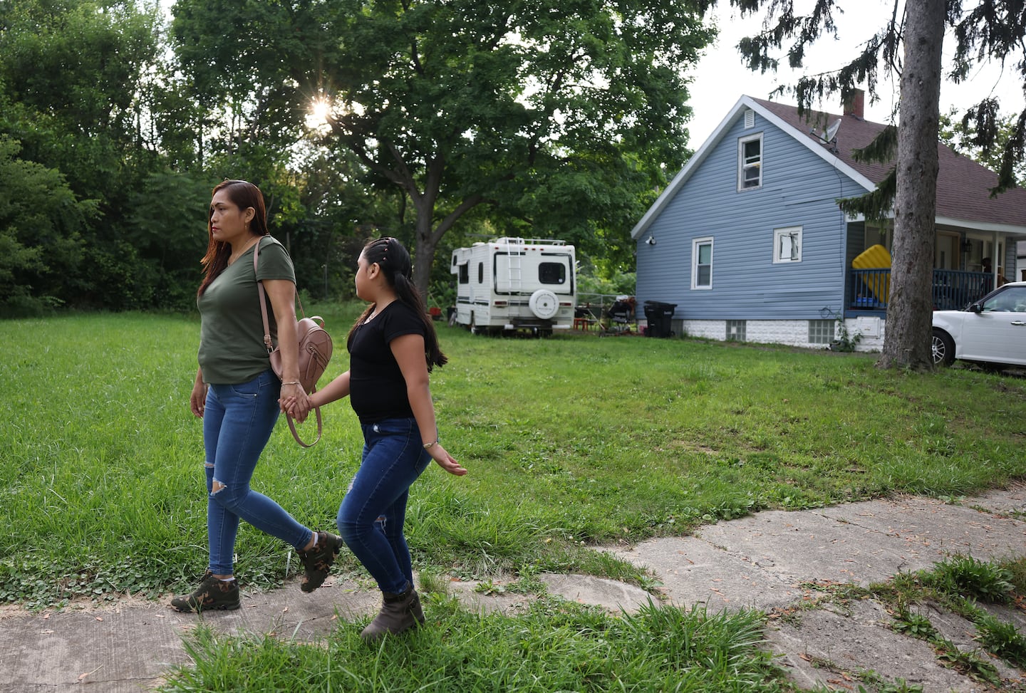 Estrella and her 9-year-old daughter held hands as they walked from the park back to their apartment in Detriot.