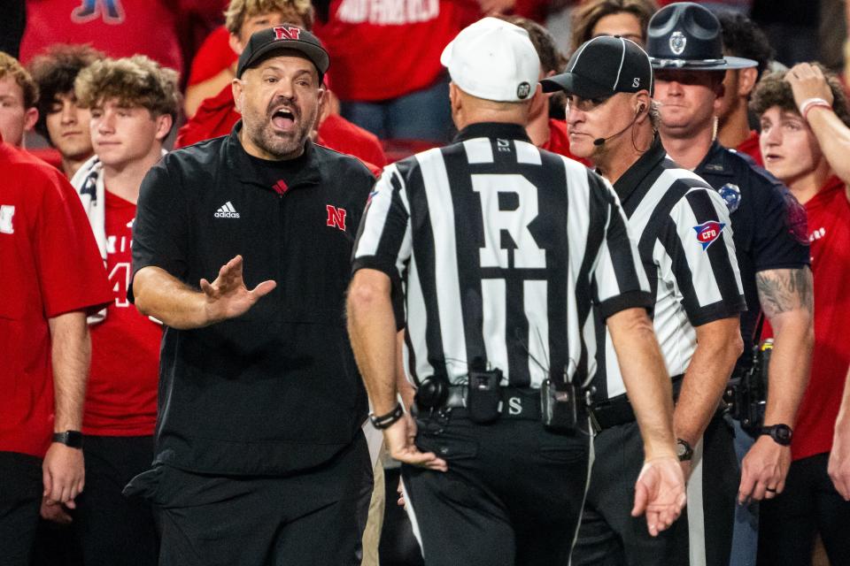 Sep 20, 2024; Lincoln, Nebraska, USA; Nebraska Cornhuskers head coach Matt Rhule talks with officials after an interception during the second quarter against the Illinois Fighting Illini at Memorial Stadium. Mandatory Credit: Dylan Widger-Imagn Images