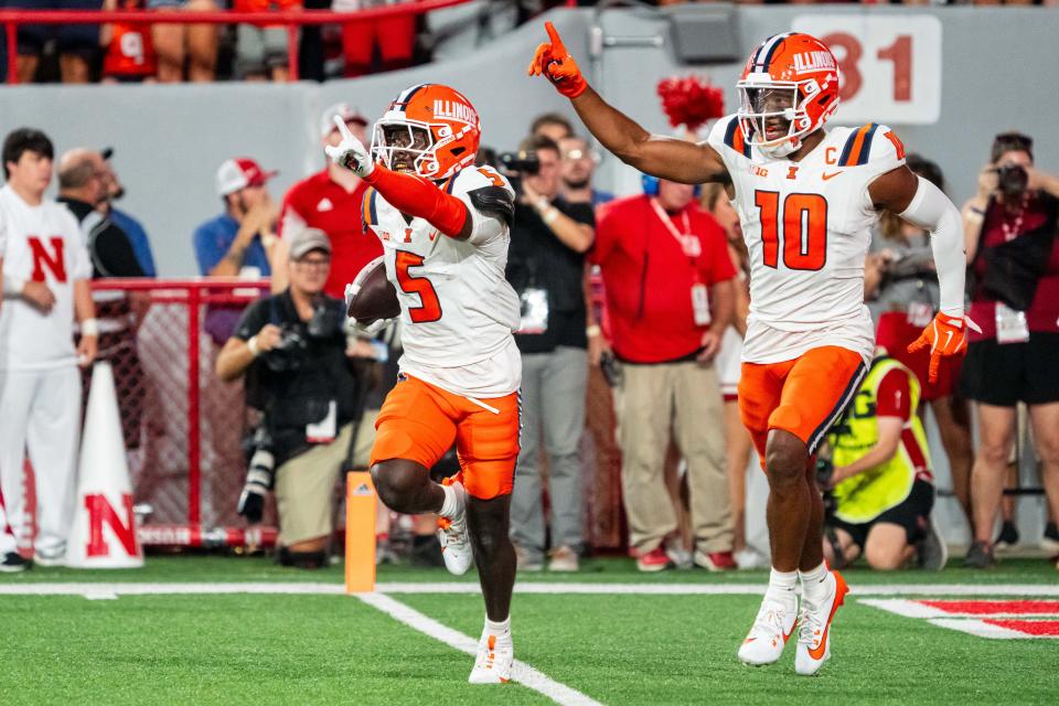 Sep 20, 2024; Lincoln, Nebraska, USA; Illinois Fighting Illini defensive back Torrie Cox Jr. (5) and defensive back Miles Scott (10) celebrate after an interception in the end zone against the Nebraska Cornhuskers during the second quarter at Memorial Stadium. Mandatory Credit: Dylan Widger-Imagn Images