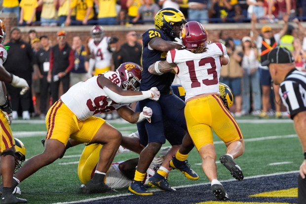 Michigan running back Kalel Mullings (20) scores on a one-yard...