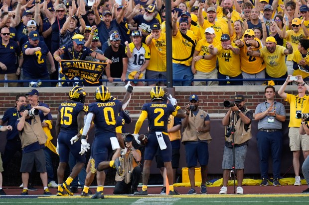 Michigan defensive back Will Johnson (2) celebrates his 42-yard interception...