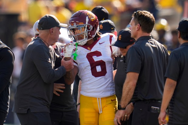 Southern California wide receiver Makai Lemon (6) is helped off...