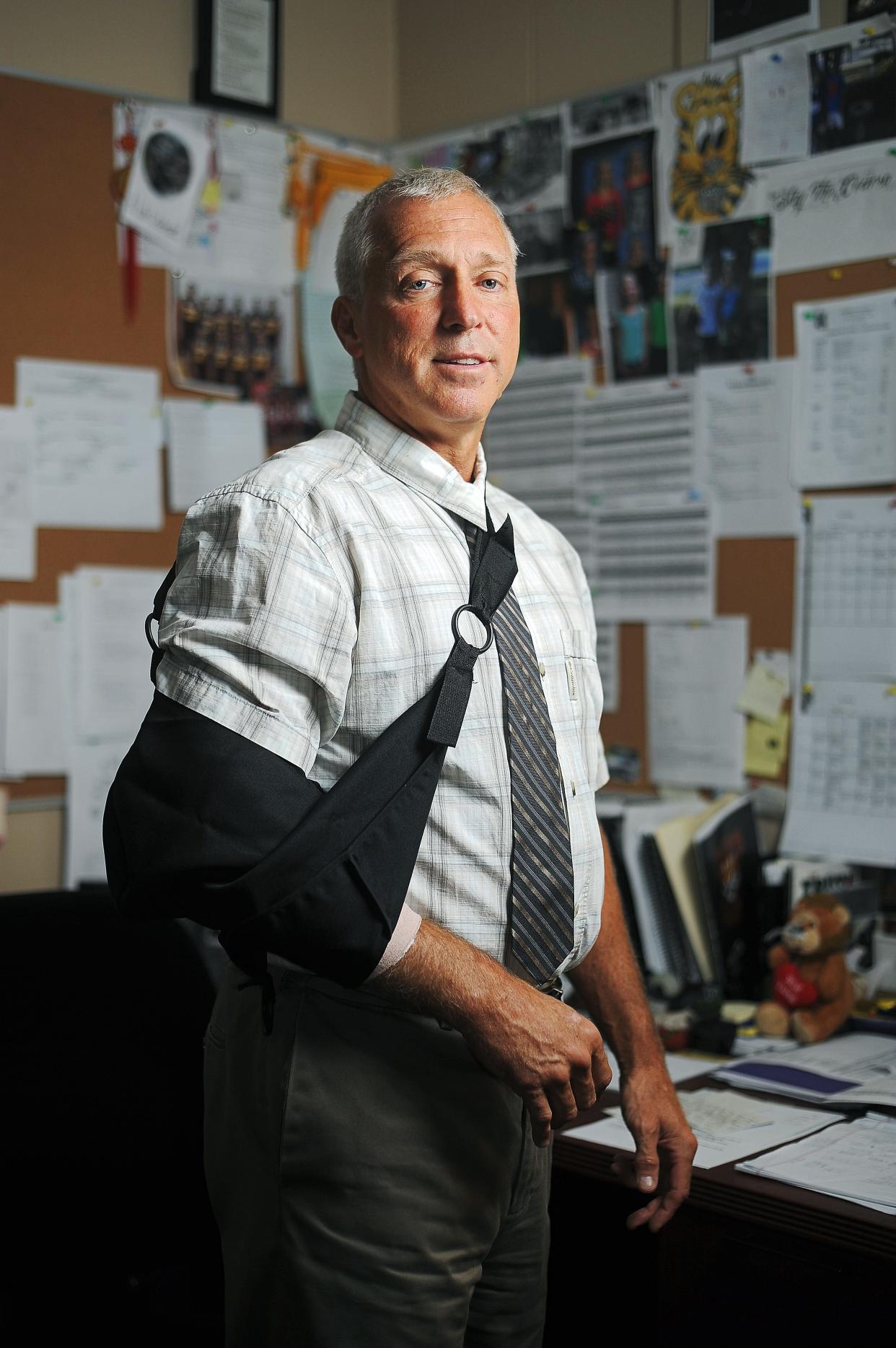 Kevin Lein, principal of Harrisburg High School, poses for a portrait Friday, Oct. 2, 2015, in his office at Harrisburg High School in Harrisburg, S.D., just days after he was shot by a student on campus. The student later pleaded guilty to attempted murder.