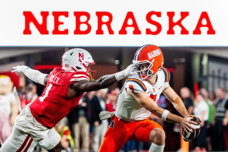 Sep 20, 2024; Lincoln, Nebraska, USA; Nebraska Cornhuskers defensive lineman Jimari Butler (1) grabs the face mask of Illinois Fighting Illini quarterback Luke Altmyer (9) during the second quarter at Memorial Stadium. Mandatory Credit: Dylan Widger-Imagn Images