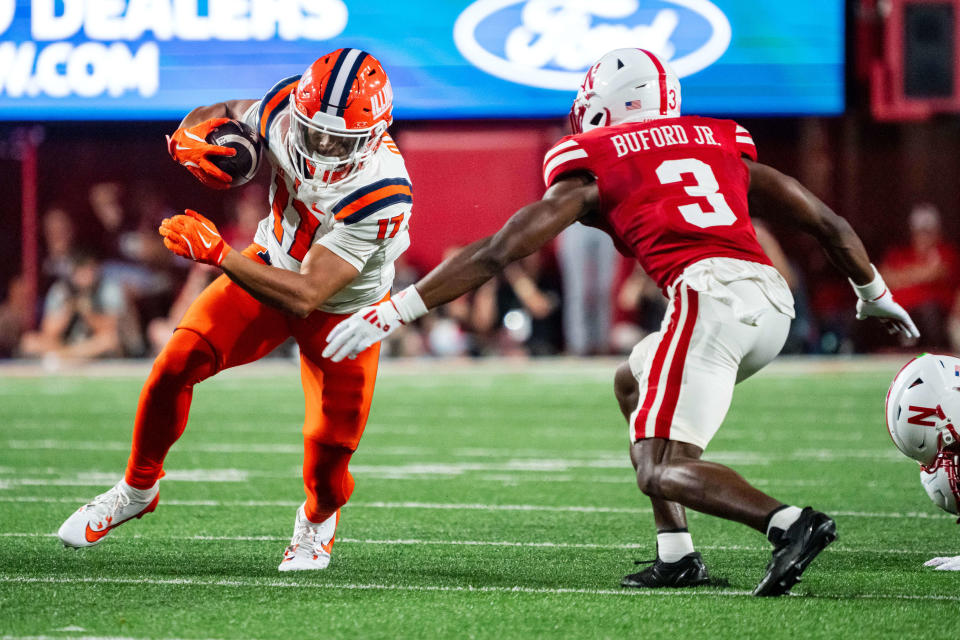 Sep 20, 2024; Lincoln, Nebraska, USA; Illinois Fighting Illini wide receiver Collin Dixon (17) runs after a catch against Nebraska Cornhuskers defensive back Marques Buford Jr. (3) during the second quarter at Memorial Stadium. Mandatory Credit: Dylan Widger-Imagn Images