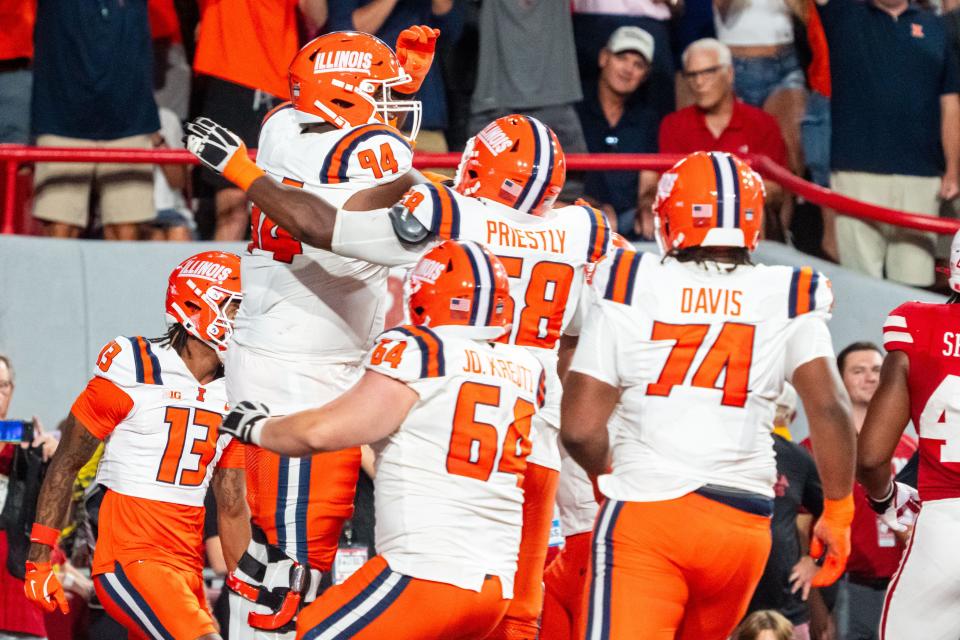 Sep 20, 2024; Lincoln, Nebraska, USA; Illinois Fighting Illini offensive lineman Brandon Henderson (94) celebrates with teammates after scoring a touchdown against the Nebraska Cornhuskers during the fourth quarter at Memorial Stadium. Mandatory Credit: Dylan Widger-Imagn Images