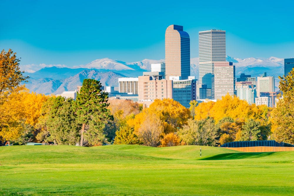 Scenic of Denver Colorado skyline. City Park and Rocky Mountains. Located in Denver, Colorado, USA.