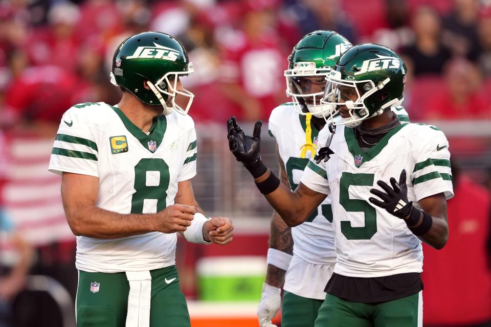 Sep 9, 2024; Santa Clara, California, USA; New York Jets quarterback Aaron Rodgers (8) and wide receiver Garrett Wilson (5) talk on the field during the second quarter against the San Francisco 49ers at Levi's Stadium. Mandatory Credit: Darren Yamashita-Imagn Images