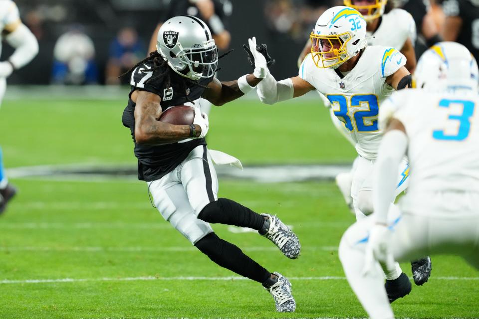 Dec 14, 2023; Paradise, Nevada, USA; Las Vegas Raiders wide receiver Davante Adams (17) runs against Los Angeles Chargers safety Alohi Gilman (32) in the first quarter at Allegiant Stadium. Mandatory Credit: Stephen R. Sylvanie-USA TODAY Sports