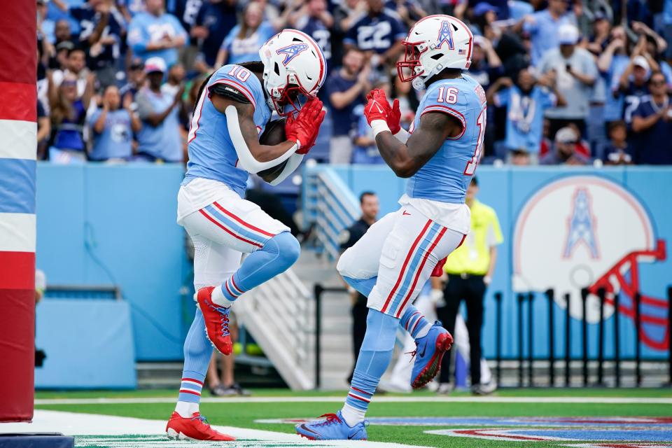 Tennessee Titans wide receiver DeAndre Hopkins (10) celebrates his touchdown against the Atlanta Falcons with wide receiver Treylon Burks (16) during the first quarter at Nissan Stadium in Nashville, Tenn., Sunday, Oct. 29, 2023.