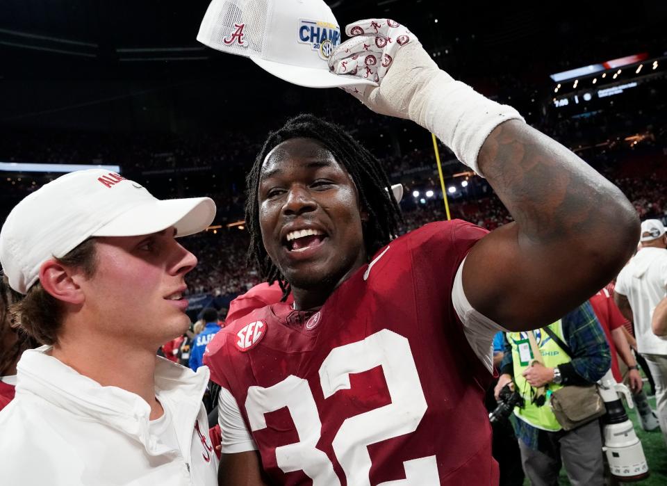 Dec 2, 2023; Atlanta, GA, USA; Alabama Crimson Tide linebacker Deontae Lawson (32) puts on an SEC Championship cap at Mercedes-Benz Stadium. Alabama defeated Georgia 27-24 to claim the SEC Championship. Mandatory Credit: Gary Cosby Jr.-USA TODAY Sports