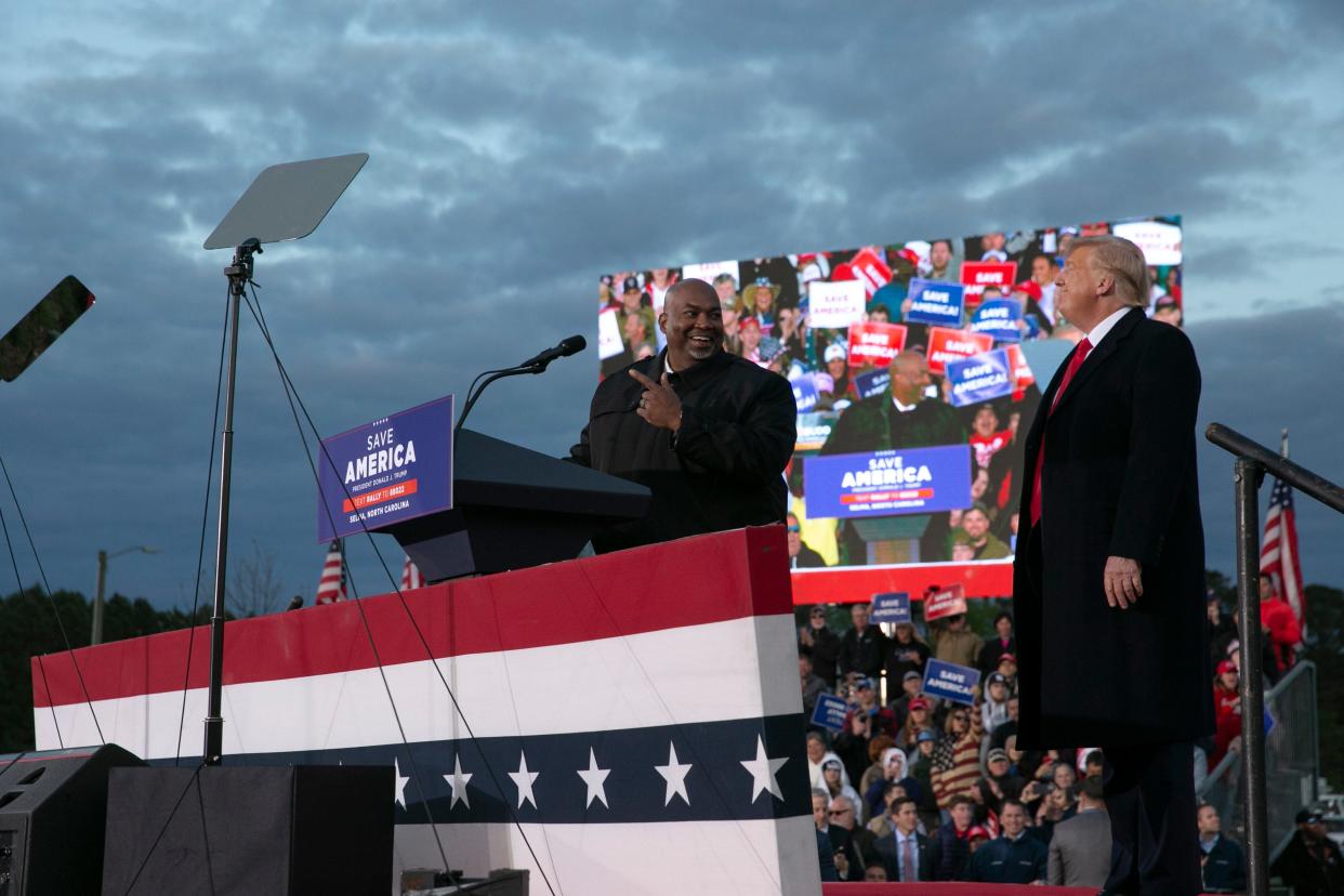 SELMA, NC - APRIL 09: Lt. Gov. Mark Robinson joins the stage with former U.S. President Donald Trump during a rally at The Farm at 95 on April 9, 2022 in Selma, North Carolina. The rally comes about five weeks before North Carolinas primary elections where Trump has thrown his support behind candidates in some key Republican races. (Photo by Allison Joyce/Getty Images)