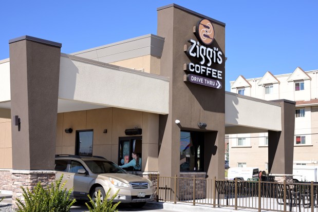 A customer gets a drive-thru order at Ziggi's Coffee shop in Arvada on Wednesday, October 25, 2023. (Photo by Hyoung Chang/The Denver Post)