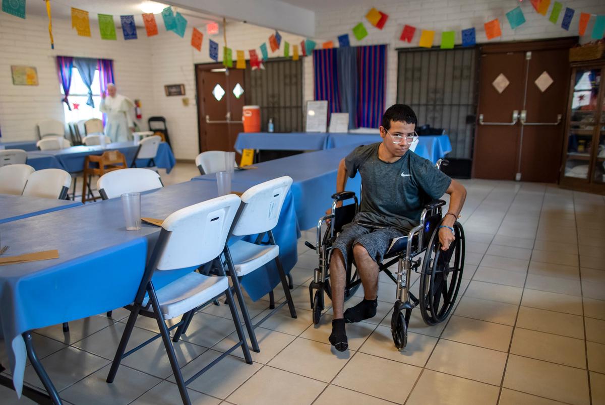 Guatemalan migrant Wilson Juarez, 22, helps set tables for lunch at the Pope Francis migrants shelter in El Paso, Texas, on Friday, Aug. 9, 2024. Juarez experienced brain injury from smoke inhalation in a Ciudad Juarez, Mexico prison fire the previous year, which impaired his ability to walk and talk and killed dozens of people.