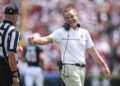 South Carolina Head Coach Shane Beamer smiles with a side judge after South Carolina quarterback LaNorris Sellers (16) ran for a touchdown against Louisiana State University during the second quarter at Williams-Brice Stadium in Columbia, S.C. Saturday, September 14, 2024.