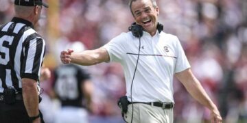 South Carolina Head Coach Shane Beamer smiles with a side judge after South Carolina quarterback LaNorris Sellers (16) ran for a touchdown against Louisiana State University during the second quarter at Williams-Brice Stadium in Columbia, S.C. Saturday, September 14, 2024.