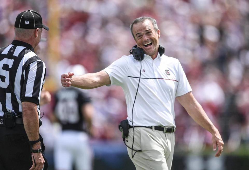 South Carolina Head Coach Shane Beamer smiles with a side judge after South Carolina quarterback LaNorris Sellers (16) ran for a touchdown against Louisiana State University during the second quarter at Williams-Brice Stadium in Columbia, S.C. Saturday, September 14, 2024.