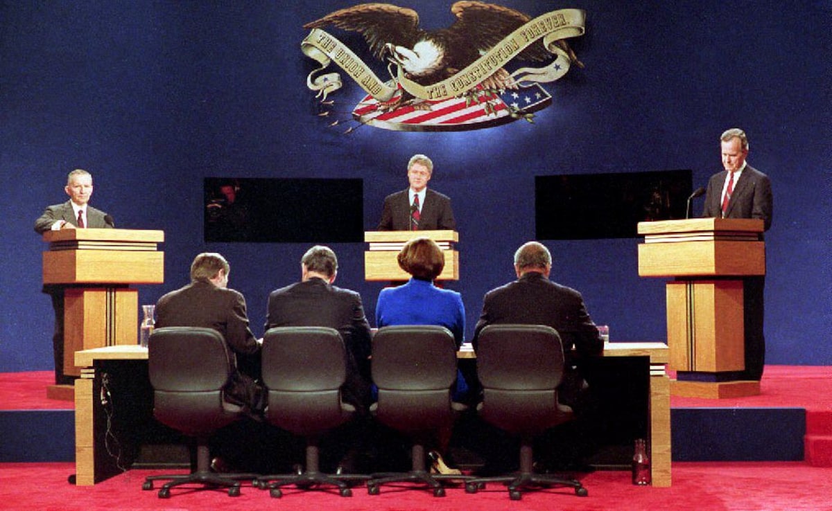 US presidential candidates Ross Perot (L), Bill Clinton (C) and George Bush (R) answer questions at the athletic center at Washington University in St Louis, Missouri during the first of three US presidential debates