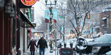 A couple walks on the snowy sidewalk on Wednesday, Jan. 10, 2024 on Phillips Avenue in Downtown Sioux Falls.