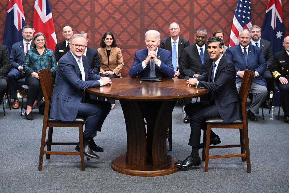 US President Joe Biden, Australian Prime Minister Anthony Albanese, and British Prime Minister Rishi Sunak sitting around a roundtable.