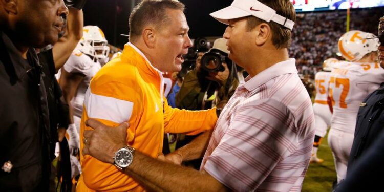 Sep 13, 2014; Norman, OK; Oklahoma Sooners head coach Bob Stoops shakes hands with Tennessee Volunteers head coach Butch Jones after the game at Gaylord Family - Oklahoma Memorial Stadium. Mandatory Credit: Kevin Jairaj-USA TODAY Sports