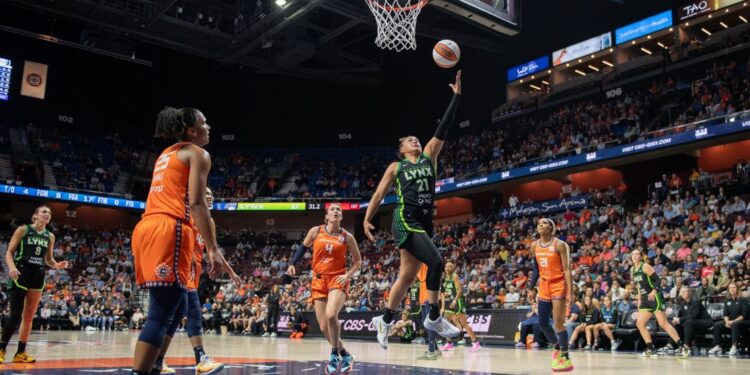 Minnesota Lynx guard Kayla McBride shoots a layup against the Connecticut Sun.