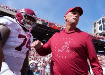 Sep 14, 2024; Madison, Wisconsin, USA; Alabama Crimson Tide head coach Kalen DeBoer greets offensive linenam Kadyn Proctor (74) prior to the game against the Wisconsin Badgers at Camp Randall Stadium. Mandatory Credit: Jeff Hanisch-Imagn Images