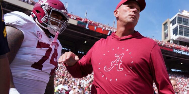 Sep 14, 2024; Madison, Wisconsin, USA; Alabama Crimson Tide head coach Kalen DeBoer greets offensive linenam Kadyn Proctor (74) prior to the game against the Wisconsin Badgers at Camp Randall Stadium. Mandatory Credit: Jeff Hanisch-Imagn Images