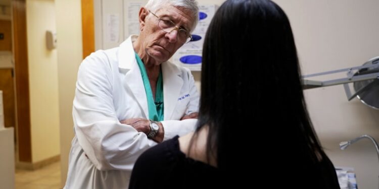 Dr. Warren Hern speaks with Willow in one of the procedure rooms at the Boulder Abortion Clinic.