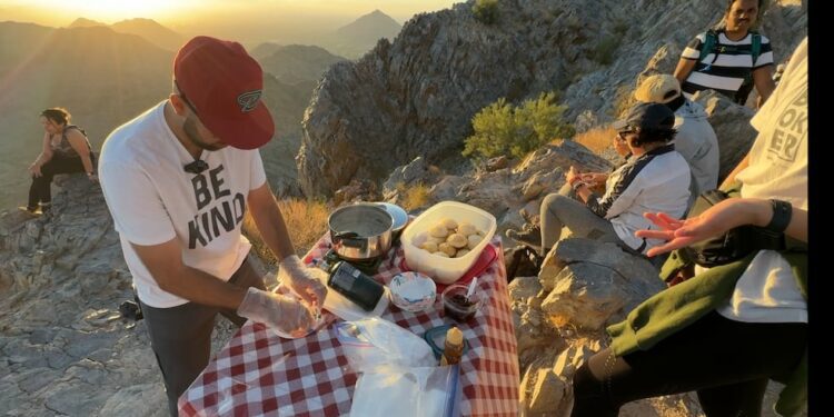 Daniel Angulo serving a hot meal at the top of Piestewa Peak