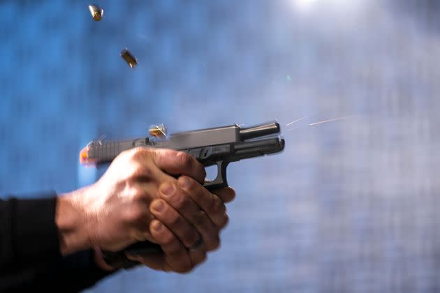 A semiautomatic pistol with a conversion device installed making it fully automatic is fired as three empty shell casings fly out of the weapon, at the Bureau of Alcohol, Tobacco, Firearms and Explosives' National Services Center in Martinsburg, West Virginia.