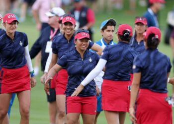 Megan Khang and Nelly Korda of Team United States react with teammates Rose Zhang and Andrea Lee after winning their match during the Friday Fourball matches against Team Europe during the first round of the Solheim Cup 2024 at Robert Trent Jones Golf Club on September 13, 2024 in Gainesville, Virginia.