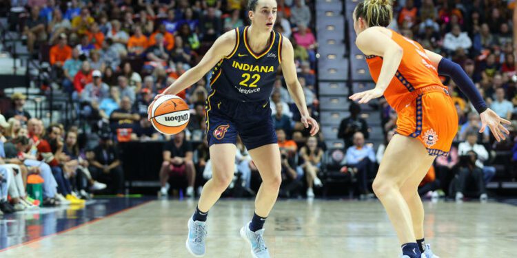 UNCASVILLE, CT - SEPTEMBER 22: Indiana Fever guard Caitlin Clark (22) defended by Connecticut Sun guard Marina Mabrey (4) during the First Round and game 1 of the 2024 WNBA playoffs between Indiana Fever and Connecticut Sun on September 22, 2024, at Mohegan Sun Arena in Uncasville, CT. (Photo by M. Anthony Nesmith/Icon Sportswire via Getty Images)