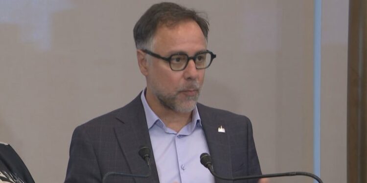 A closeup of Plateau-Mont-Royal borough mayor Luc Rabouin's face as he speaks to reporters.