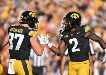 Iowa Hawkeyes tight end Addison Ostrenga (87) and running back Kaleb Johnson (2) react after a touchdown by Johnson during the third quarter against the Iowa State Cyclones at Kinnick Stadium.