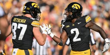 Iowa Hawkeyes tight end Addison Ostrenga (87) and running back Kaleb Johnson (2) react after a touchdown by Johnson during the third quarter against the Iowa State Cyclones at Kinnick Stadium.