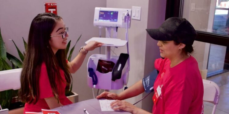 A medical assistant takes a woman's blood pressure.