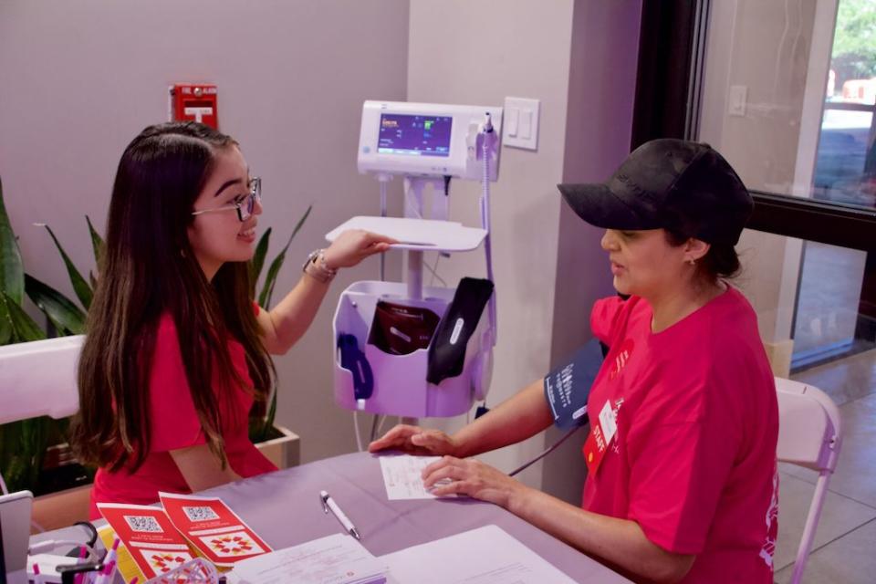 A medical assistant takes a woman's blood pressure.