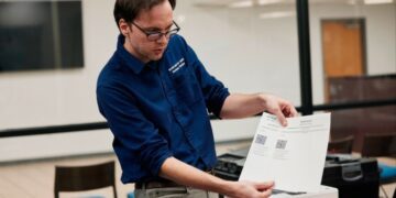 An election official carries out an elections security health check at the Dekalb County election headquarters