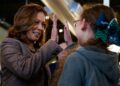 U.S. Vice President Kamala Harris high-fiving a middle school student during her presidential campaign in Pittsburgh, Pennsylvania.