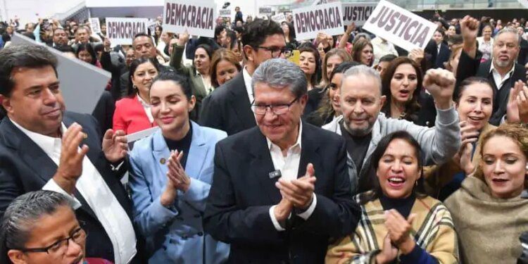 Deputy Ricardo Monreal stands at the front of a crowd celebrating the passage of the judicial reform bill in Mexico's Chamber of Deputies