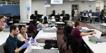 FILE - County employees open ballots in the mail ballot processing room at the Washoe County Registrar of Voters office in Reno, Nev., June 3, 2024. (AP Photo/Andy Barron, File)